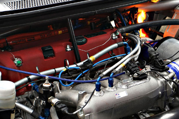 A fire burns in the engine bay at Oulton Park