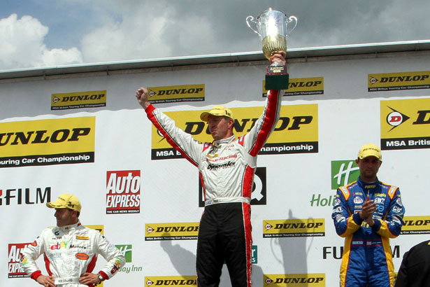 Matt Neal celebrates winning the first race of the day