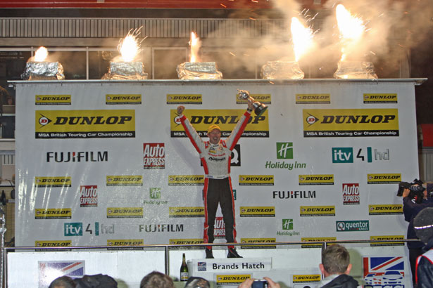 Gordon Shedden lifts the BTCC Drivers Championship trophy