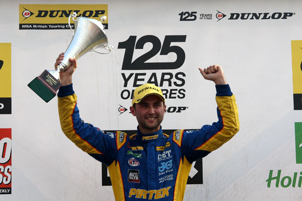 Andrew Jordan lifts the winner's trophy for race 3