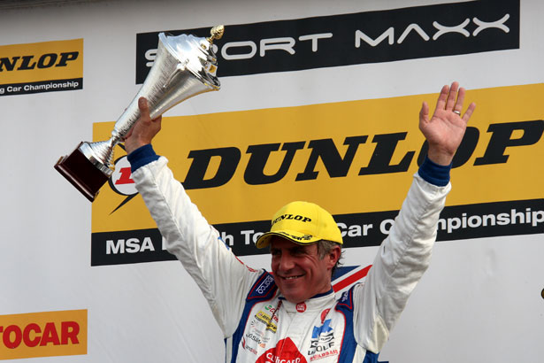 Jason Plato on the podium after winning race 1 from Silverstone