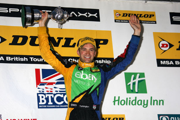 Colin Turkington lifts the BTCC Drivers' Championship trophy