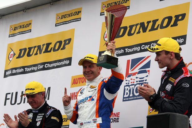 Rob Collard lifts the first winner's trophy of the 2015 BTCC season