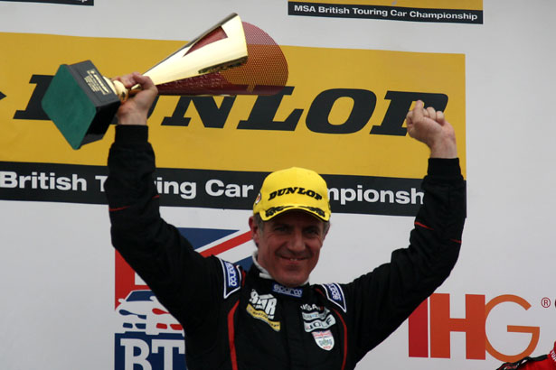 Jason Plato lifts the first BTCC winner's trophy of the day