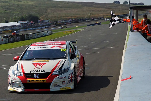 Gordon Shedden takes the chequered flag to delight the crowd