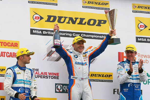 Rob Collard celebrates his victory on the podium at Croft