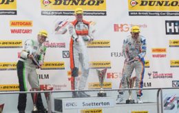 Gordon Shedden takes the top step of the podium after last lap victory